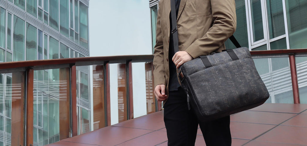 black cork & hanji briefcase from the brand eKodoKi, carried by male model, as desktop banner