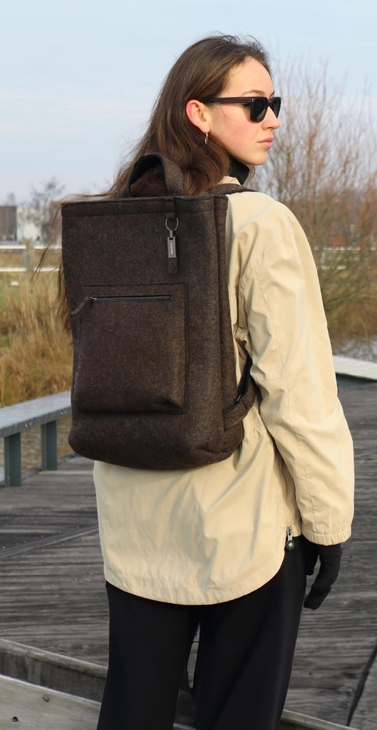 brown wool felt courier backpack carried by female model, used as mobile banner