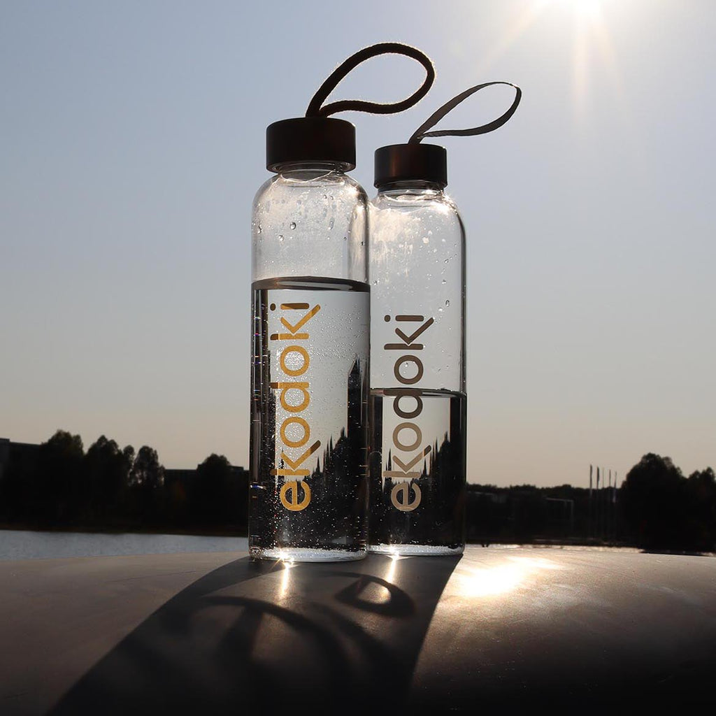 two reusable glass bottles from the brand eKodoKi, used to illustrate the brand's collection of glass accessories