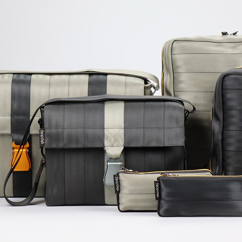 four seatbelt bags and two seatbelt pouches from the brand eKodoKi, used to illustrate the brand's collection of upcycled seatbelt bags and soft accessories