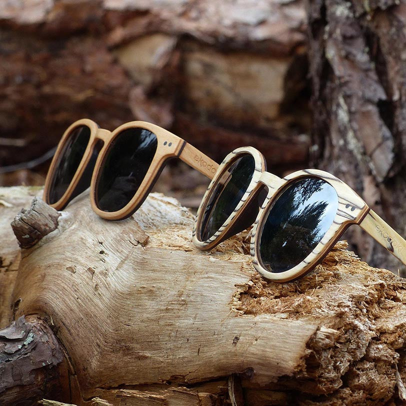 two wooden sunglasses from the brand eKodoKi, used to illustrate the brand's collection of wooden accessories