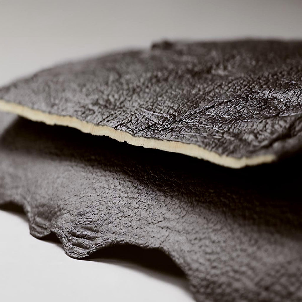 close up detail of two pieces of black hanji textile, otherwise known as 'haunji'