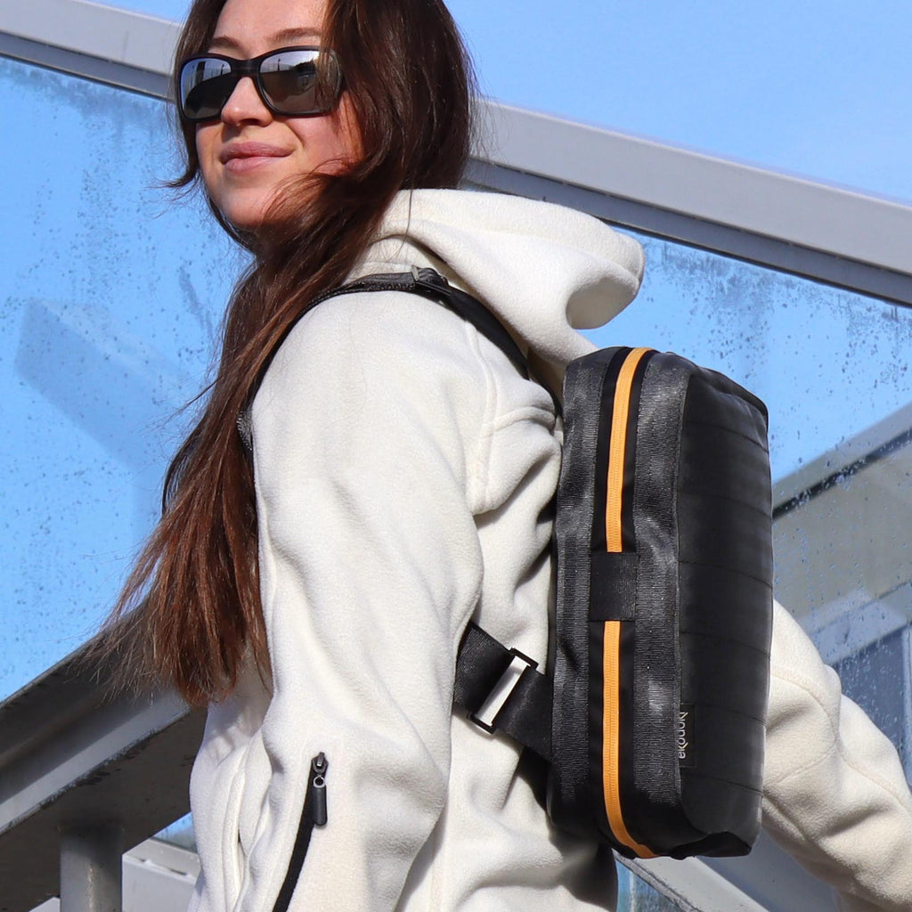 black seatbelt backpack M on female fashion model shoulders side view eKodoKi RE-BELT