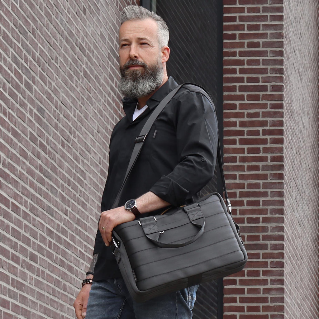 black seatbelt briefcase M on male fashion model on left shoulder standing eKodoKi RE-BELT