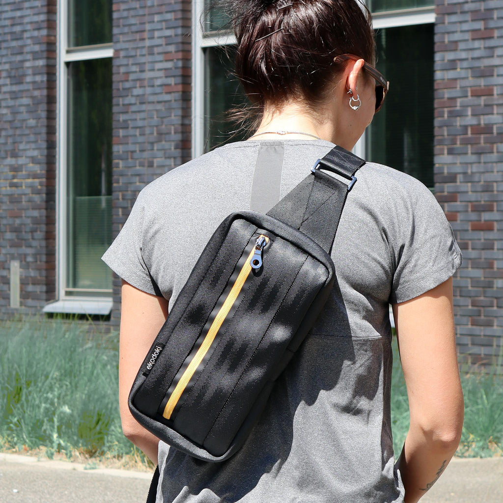 black seatbelt sling bag M on female fashion model back eKodoKi RE-BELT