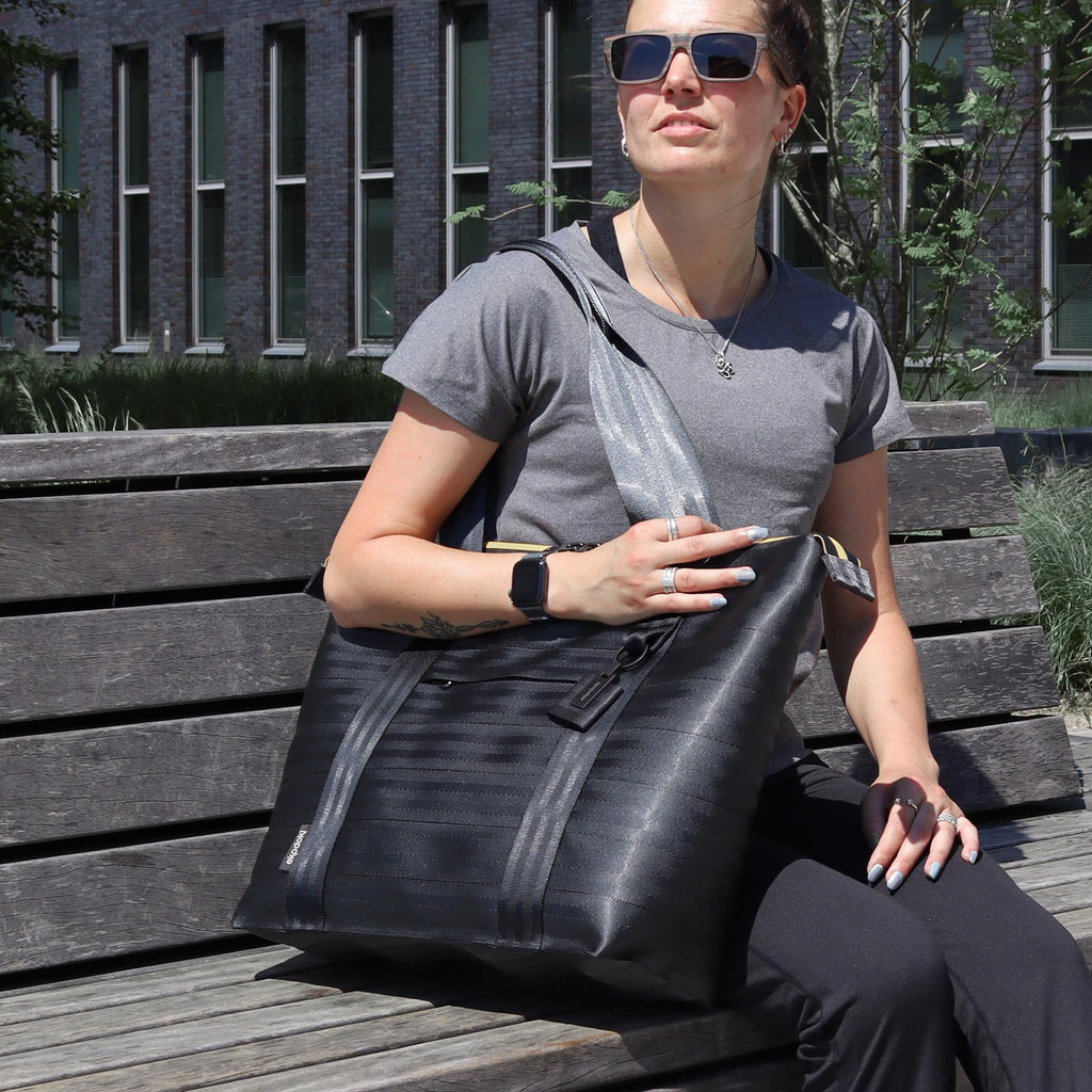 black seatbelt tote bag L used by female fashion model sitting eKodoKi RE-BELT