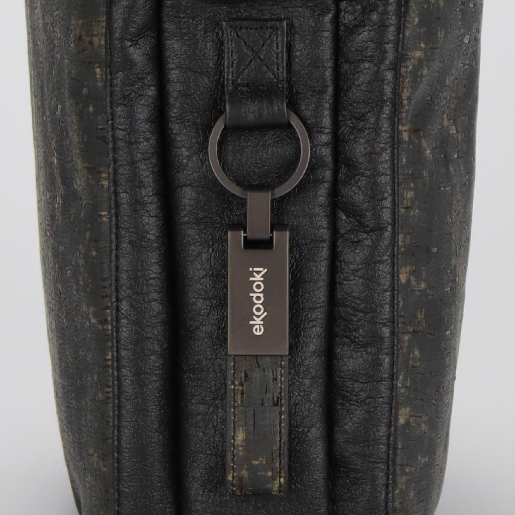 detail of an aluminium keyring used as branding on the KWORK briefcases from the brand eKodoKi