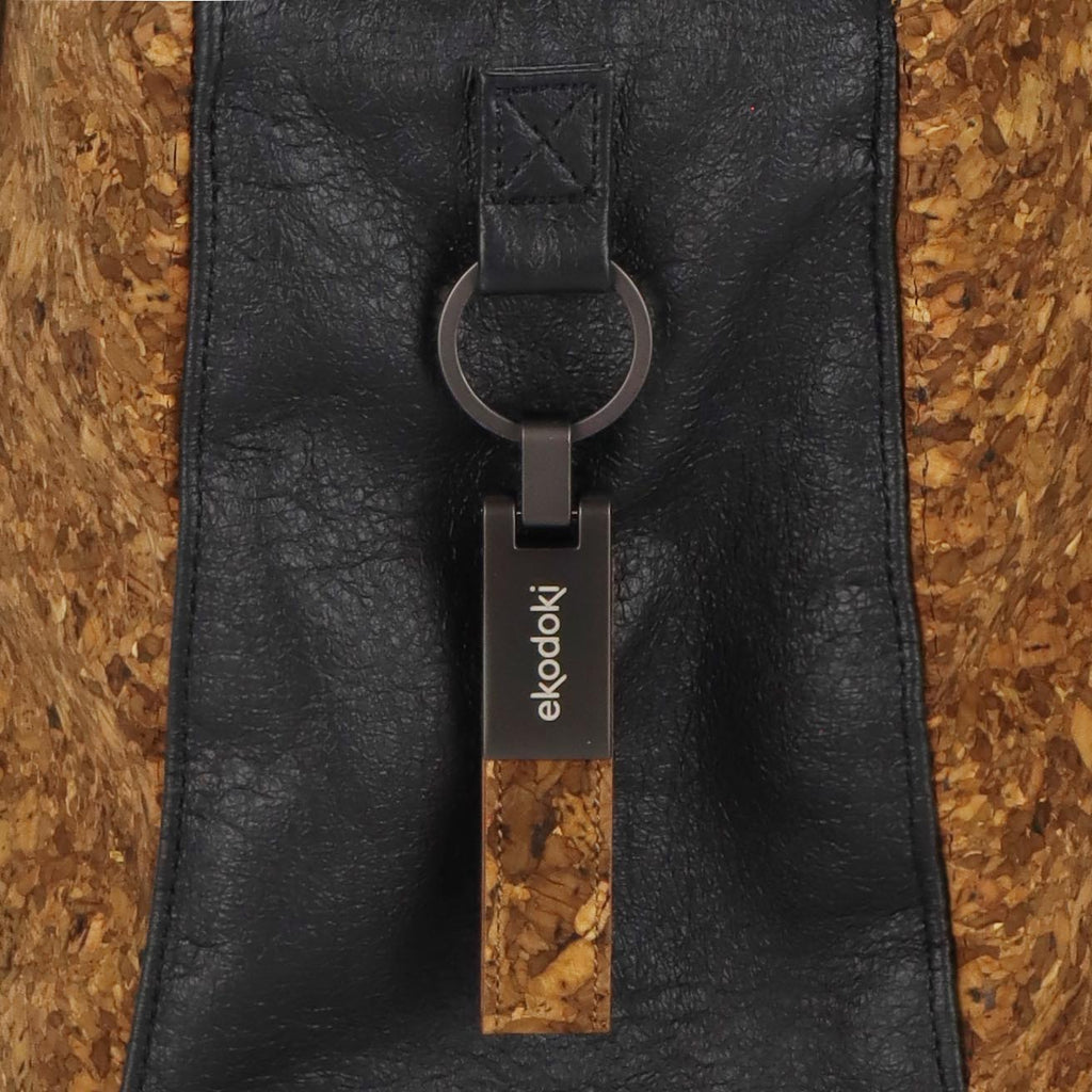 detail of an aluminium keyring used as branding on the KWORK shoulder bags from the brand eKodoKi