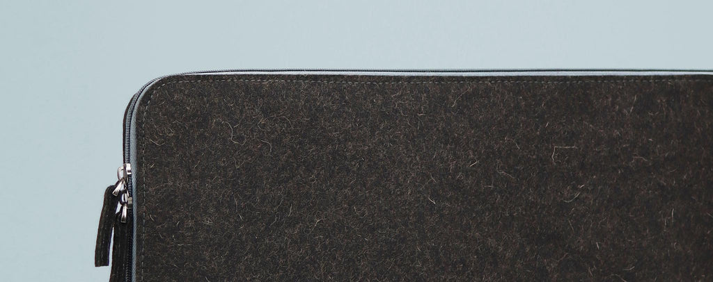 detail of a real wool laptop sleeve from the WOOLI collection from the brand eKodoKi, used as desktop banner