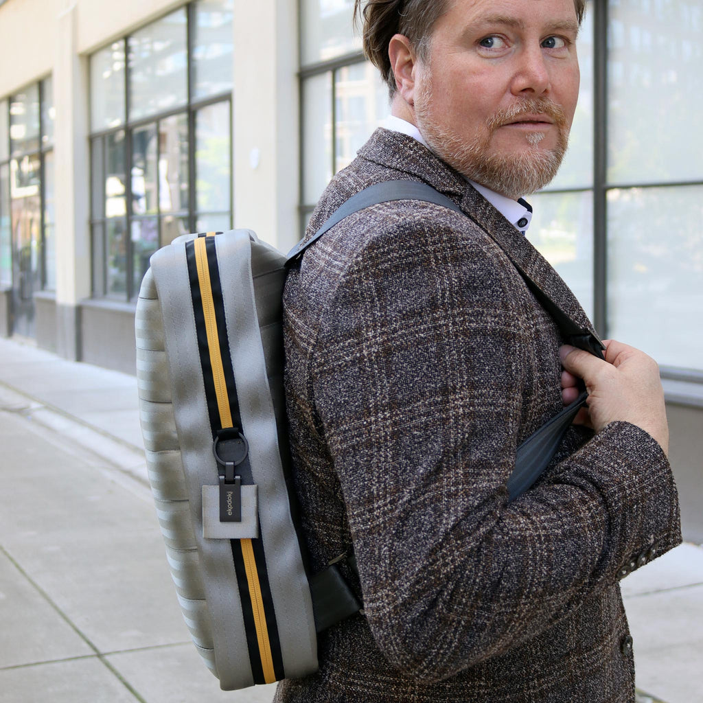 silver seatbelt backpack L on caucasian fashion model shoulders side view eKodoKi RE-BELT