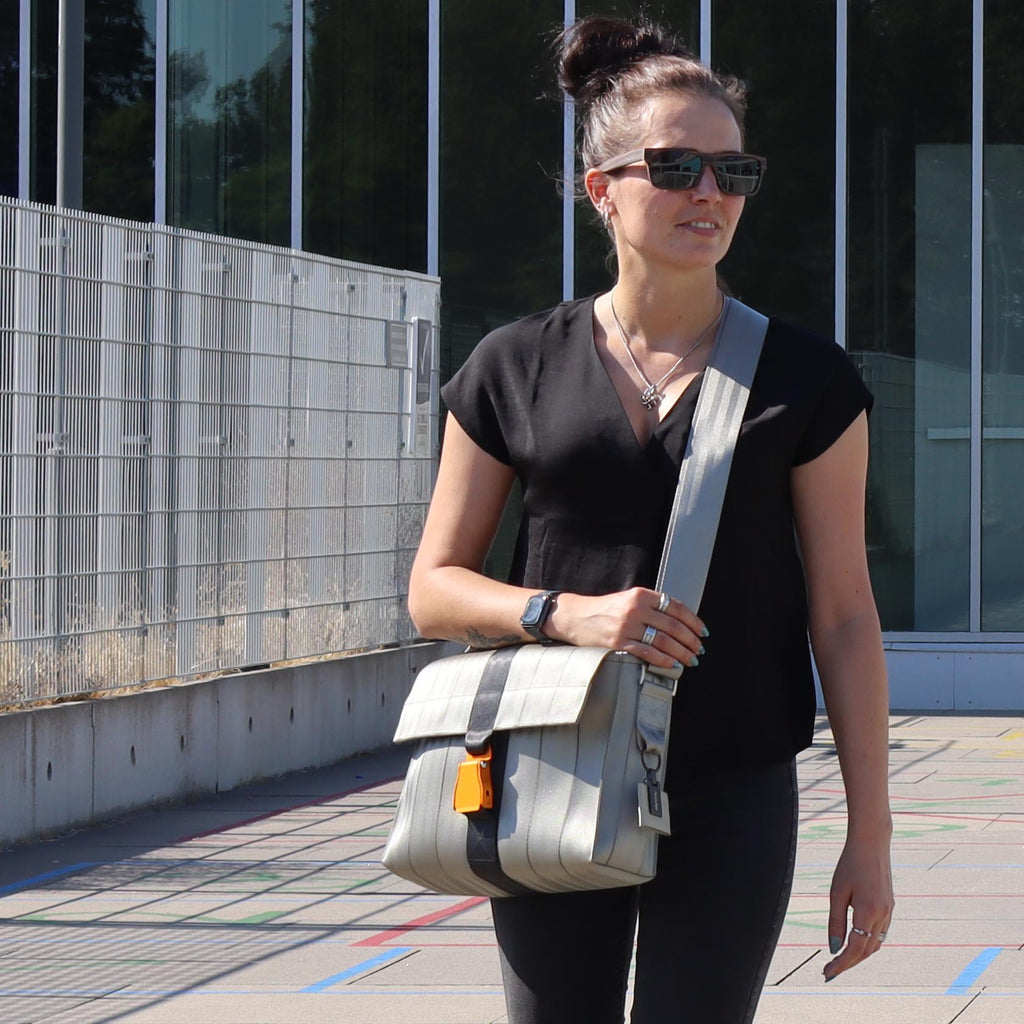 silver seatbelt messenger bag M on female fashion model walking eKodoKi RE-BELT