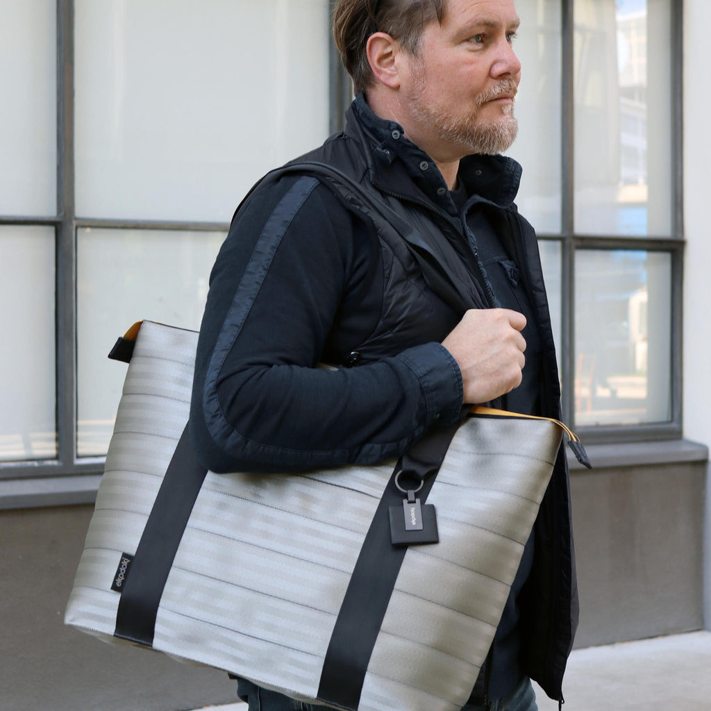 silver-seatbelt-tote-bag-L-on-male-fashion-model-right-shoulder-standing-eKodoKi-RE-BELT