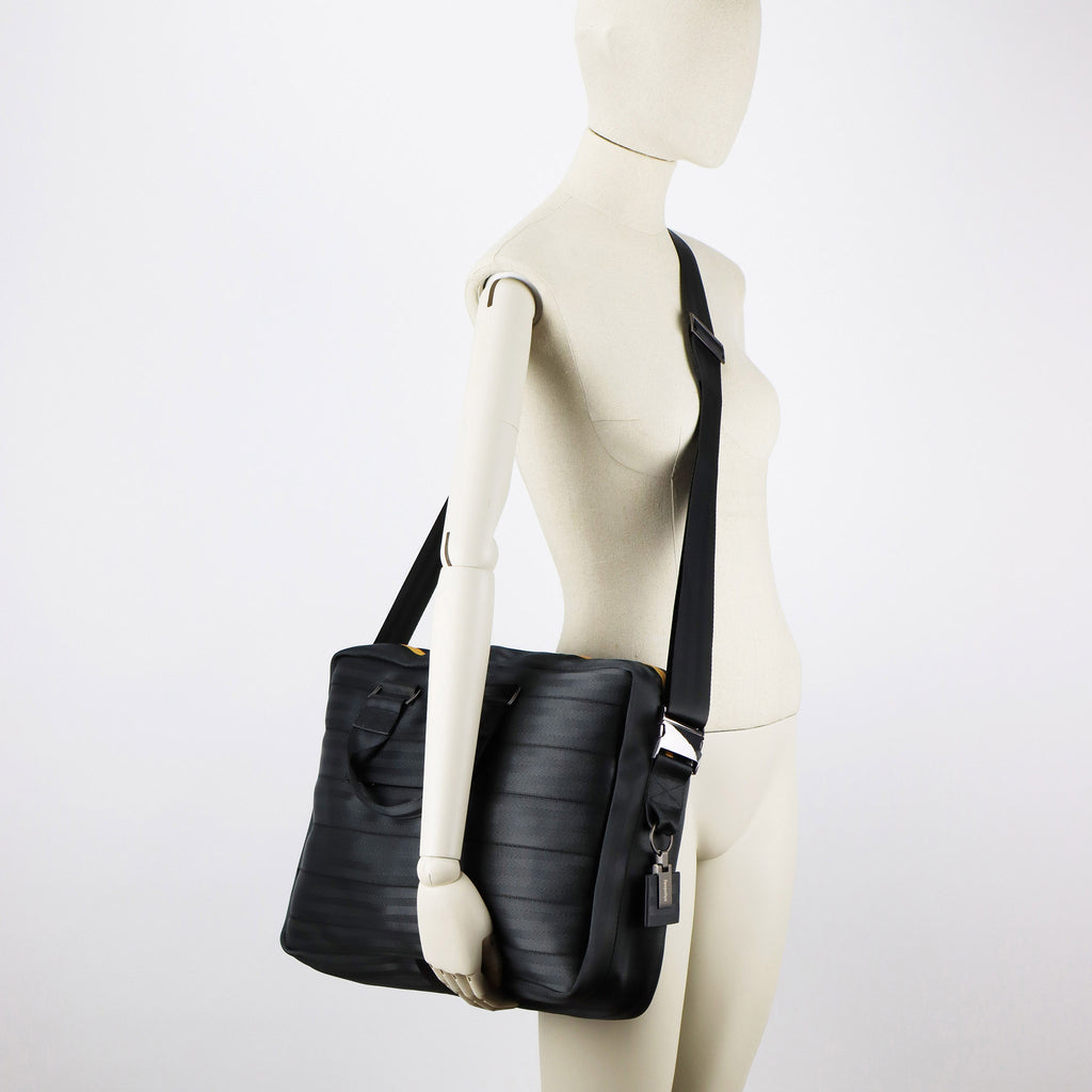 black seatbelt briefcase L on female mannequin shoulder eKodoKi RE-BELT