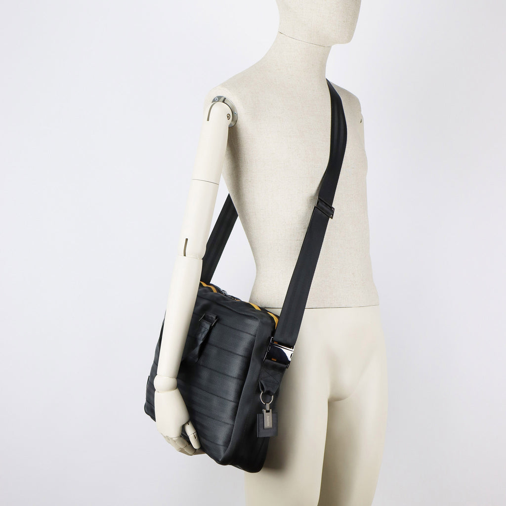 black seatbelt briefcase L on male mannequin shoulder eKodoKi RE-BELT
