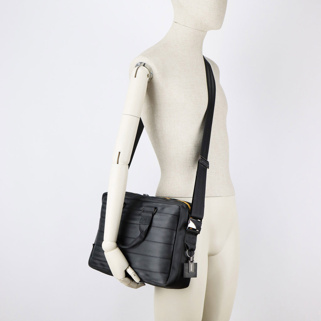 black seatbelt briefcase M on male mannequin shoulder eKodoKi RE-BELT