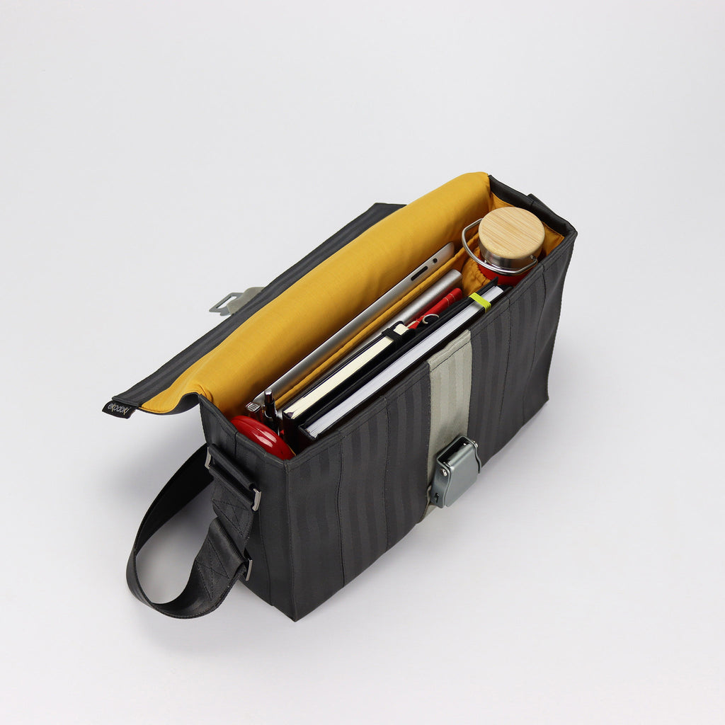 black seatbelt messenger bag M inside with bottle and documents eKodoKi RE-BELT