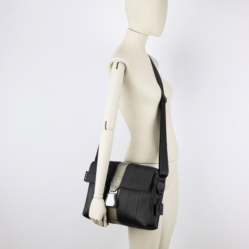 black seatbelt messenger bag M on female mannequin shoulder eKodoKi RE-BELT