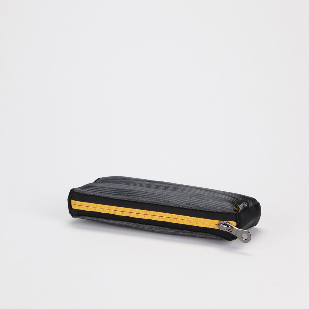 black seatbelt pen pouch with yellow zipper laying eKodoKi RE-BELT