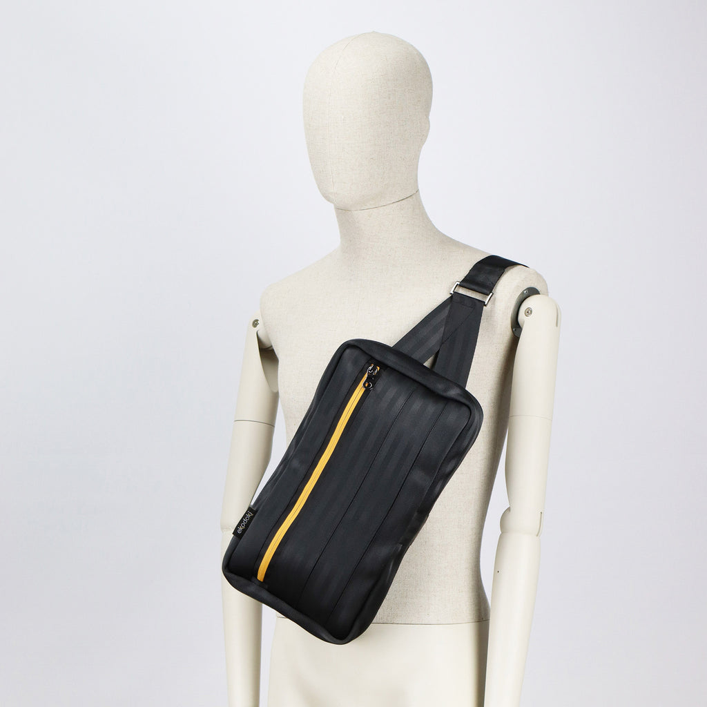black seatbelt sling bag L on male mannequin chest eKodoKi RE-BELT