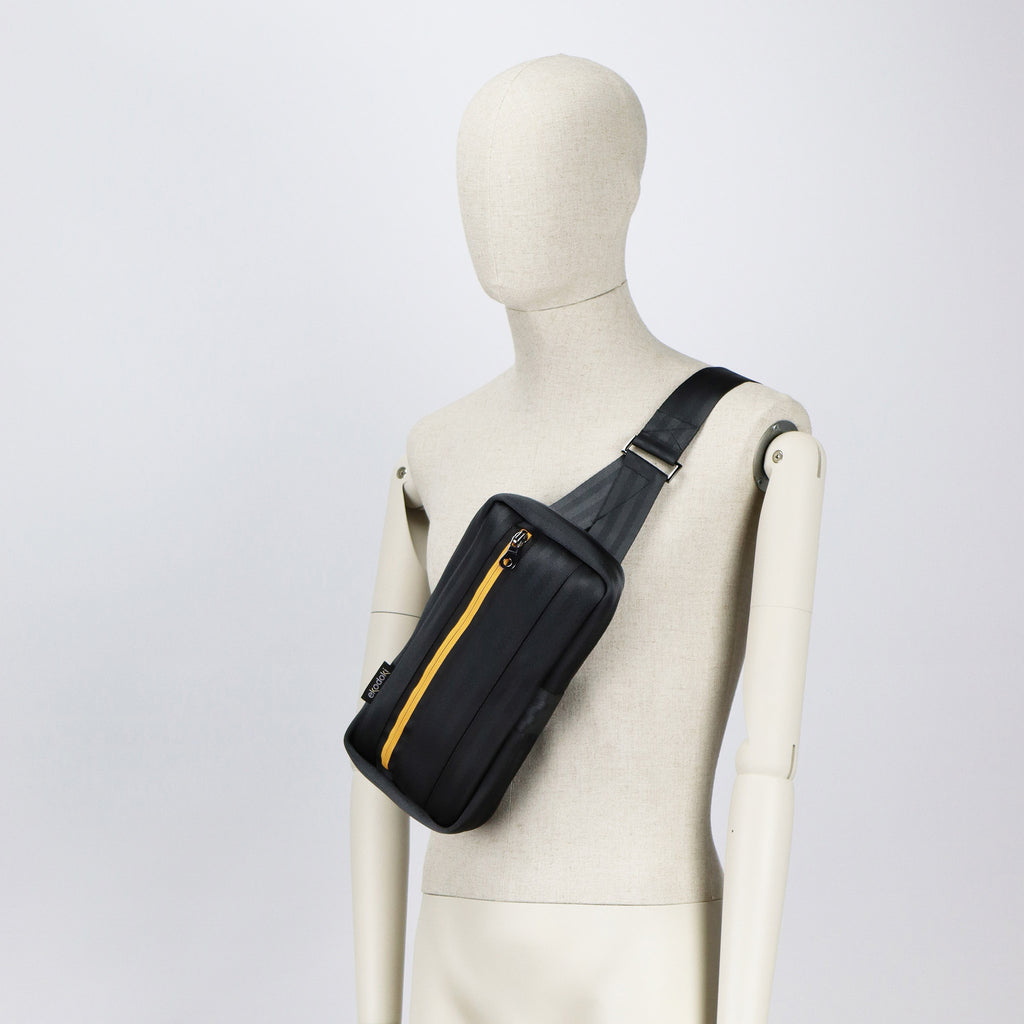 black seatbelt sling bag M on male mannequin chest eKodoKi RE-BELT