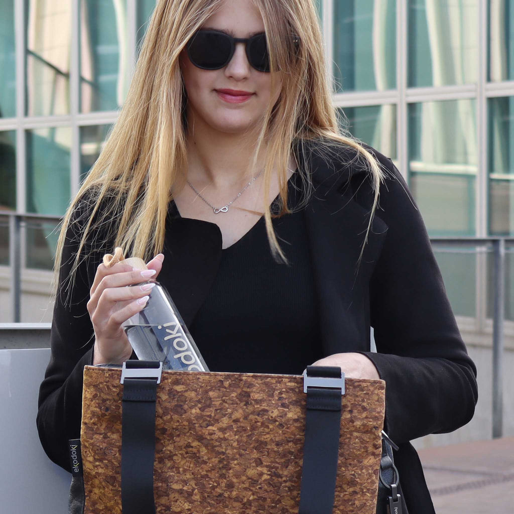 reusable glass water bottle 550ml taken out from her bag by a female model eKodoKi HYDRO