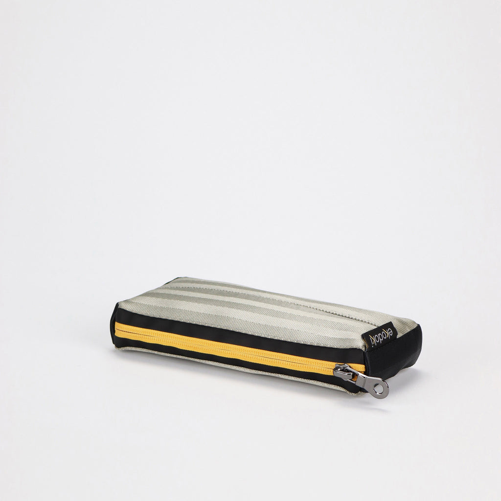 sand seatbelt pen pouch with yellow zipper laying eKodoKi RE-BELT