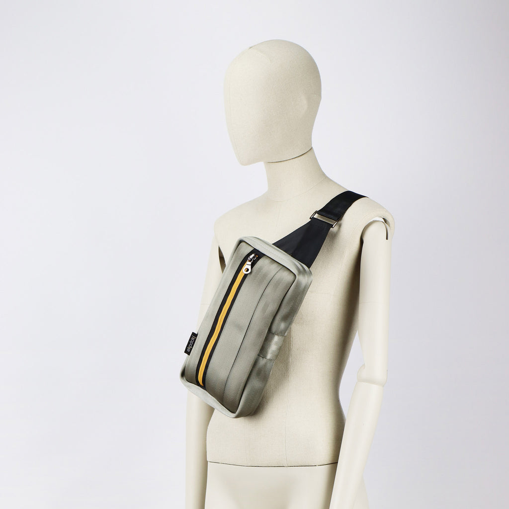 sand seatbelt sling bag M on female mannequin chest eKodoKi RE-BELT