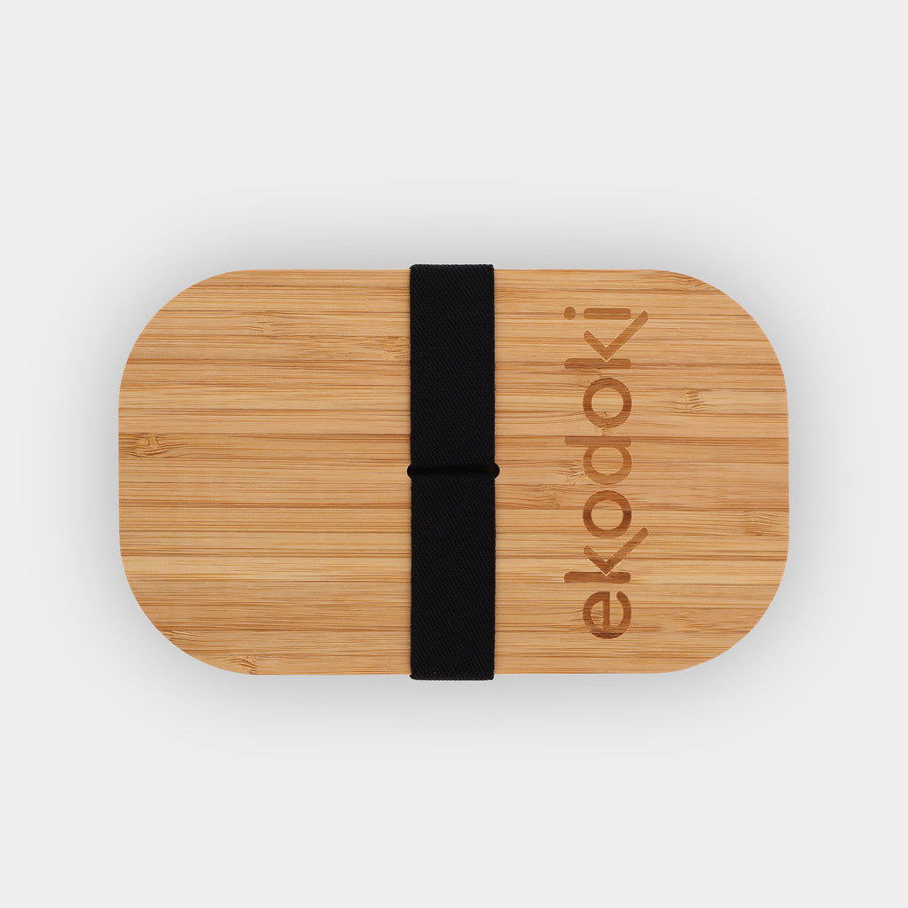 white lunchbox 1100ml 37oz with natural bamboo lid and built-in black elastic fabric strap wrapped around flatlay eKodoKi BENTO