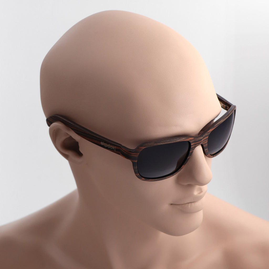 wooden sunglasses bug eye style striped ebony wood smoke lenses on tan male mannequin head eKodoKi FLY
